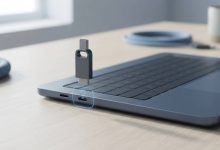 USB flash drive hovering near a laptop port with a visual gap suggesting a failed connection